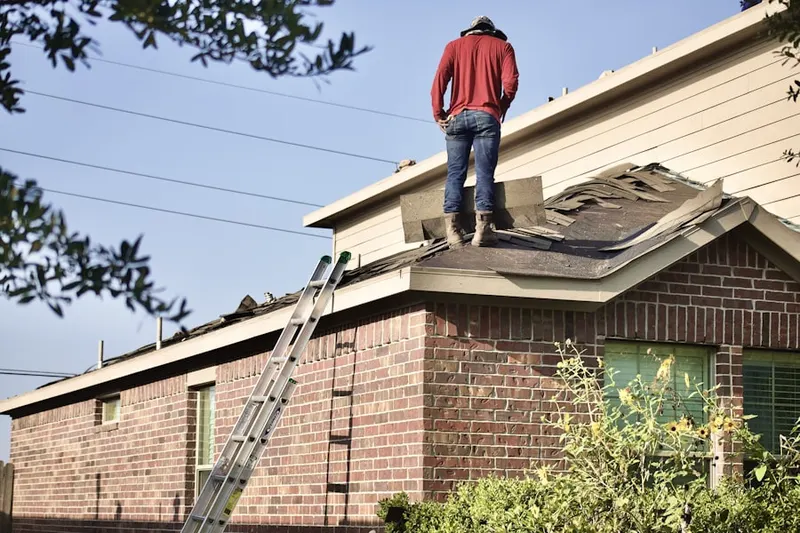 Professional roofer working on a residential roof in Westmore